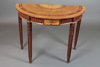 A 19th Century French stained beech wood demi-lune side table  in the Louis XVI style, the later floral marquetry top centred with  a boxwood fan, above a fluted frieze and square tapered legs,  relief carved with bell flowers, 30"h x 38"w x 19"d