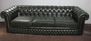 A 19th Century style green leather 3 seat Chesterfield settee with buttoned upholstery, fitted loose cushions, 95"
