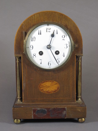 An Edwardian mahogany mantel clock, the arch topped case  decorated with bat wing patterae and brass columns, having  Arabic painted dial, the 8 day movement signed Japy Freres and  chiming gong 11"h x 7"w x 5"d