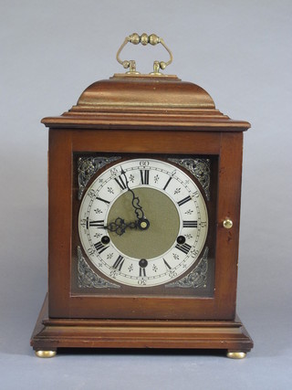 A mid 17th Century style walnut bracket clock, the case with bell  top and plinth base with bun feet, set Roman and Arabic silvered  chapter ring, mask spandrels, with 8 day quarter repeating  movement chiming on 4 gongs 13"h x 9"w x 7.5"w