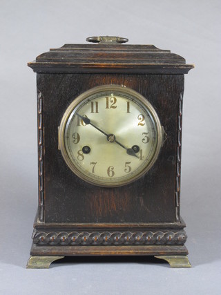 An early 20th Century oak mantel clock, the architectural case decorated carved guilloche and Roman silvered dial, set 8 day  movement, chiming gong, 11."h x 8"w x 5.5"d