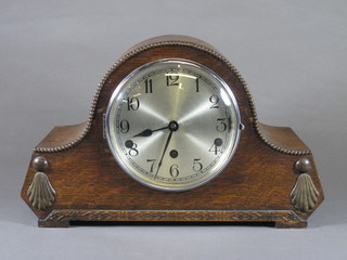 A 1930's oak mantel clock, the silvered Arabic dial set 8 day movement with Whittington & Westminster chimes on 9 gongs,  signed Kienzle 9"h x 14.5"w x 6"d