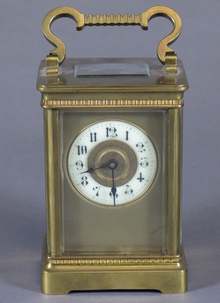 An early 20th Century French gilt brass corniche carriage timepiece having Arabic enamelled dial, lever escapement, raised  on a plinth base, 6"h x 3"w x 2.5"d