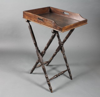 An 18th Century style oak butler's tray on stand, having galleried tray top, raised on a ring turned folding base, peg feet 38"h x  26"w x 19"d