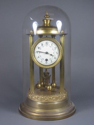 A late 19th Century gilt brass torsion timepiece, having Arabic  enamelled dial, set 8 day movement, under glass dome on  circular plinth base 16"h x 8.5"diam.