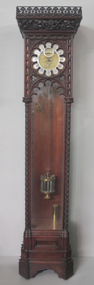 Aubert & Klaftenberger, 157 Regent Street, London. An unusual walnut floor-standing domestic regulator in the Gothic taste circa  1865. The single train movement with dead beat escapement, set  silvered Roman chapter ring with outer minute track and second  subsidiary dial, incorporating an unusual brass and glass rod  pendulum, fitted 12 brass capped mercury vials with adjustment  pointer to base. The case, with foliate carved and pierced  cornice above a hollow high relief carved band of flowers, the  door with arched apertures flanked by flower heads and lattice  pilasters, raised on chamfered and shaped plinth base 79.5"h x  18"w x 14"d  ILLUSTRATED FRONT COVER
Aubert & Klaftenberger was created in 1835 by an International partnership of 2 watch retailers, the London based C.J. Klaftenberger and D.F. Aubert of Geneva.  The firm was held in high esteem by Prince Albert, receiving regular orders for clocks and watches from 1845 onwards and favoured by both the Queen and the Prince as the supplier of watches to be presented as gifts.   The Company was also contributor to the Horological Section of the Great Exhibition, winning the Honourable Mention from the Jury.  In 1859 Aubert & Klaftenberger were awarded a Royal Warrant 