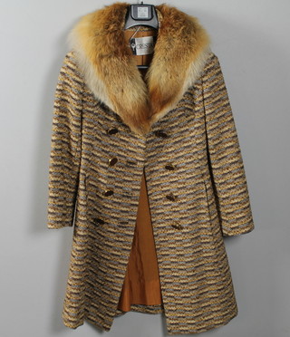A lady's coat with fur trim by Cresta
