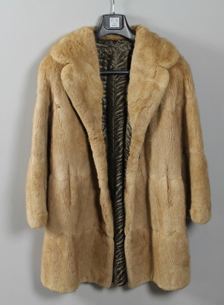 A lady's three quarter length light brown mink fur coat
