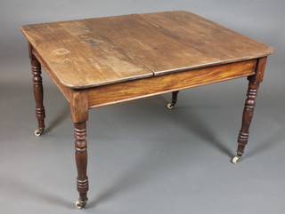 A 19th Century mahogany and stained beechwood dining table  having a rectangular top, raised on ring turned tapered legs with  china casters 29"h x 36"w 46"l