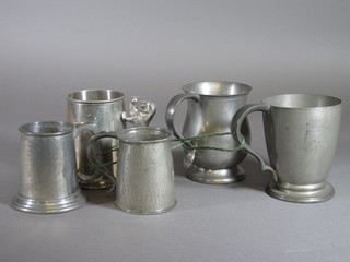 A Tudric planished pewter half pint tankard, base marked Tudric  Pewter 01288, an English pewter tankard and 3 others
