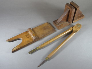 A wooden folding boot jack marked GJC 1831, a pair of wooden  bookends and a wooden compass