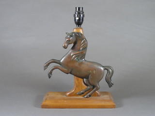 A teak and bronze table lamp in the form of a rearing horse 11"