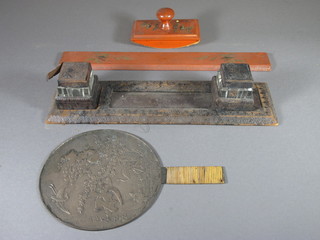 An Oriental bronze hand mirror, an Eastern blotter, ruler and a leather covered desk set