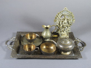 An Eastern gilt metal figure of a Deity 6.5" and an 8 piece  Benares brass teaset