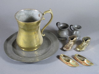 An 18th Century circular pewter plate the reverse with touch  marks 9", a large brass tankard, 2 miniature pewter spirit measures, 2 brass models of boots and 2 Turkish brass ashtrays in  the form of slippers
