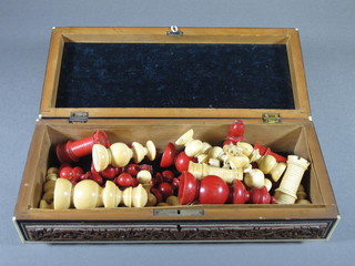 A 19th Century carved red and white ivory chess set, some  damage to white queen and rooks, contained in an Eastern carved  hardwood box