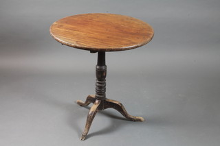 A Victorian mahogany tilt top tea table, the circular top raised upon a ring turned tapered column support, tripod base, 29"h x  27" diam