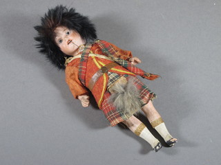A German porcelain headed doll dressed as a Scotsman, head  incised Germany 12/0