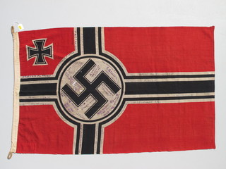A Third Reich German flag captured during the liberation of  Paris by 30 Commando Assault Unit, signed by all members of  the mission 50" x 30", together with a letter of provenance