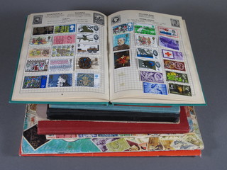 A green Improved postage stamp album, a blue Commando  illustrated stamp album, a red Champion album, a Gay Venture  album, a Global Master stamp album, a Stanley Gibbons Postbox  stamp album, a Netto stock book and 1 other album