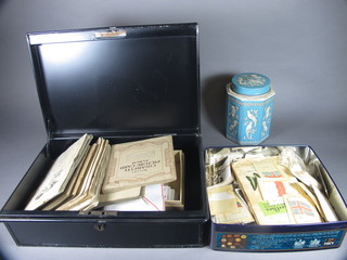 A collection of cigarette cards contained in a metal deed box, a  biscuit tin and a tea caddy