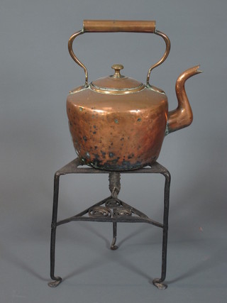A Victorian circular copper kettle 10" and a wrought iron 2 tier kettle stand