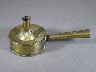A circular brass side handled candlestick the base incorporating a tinder box and an 18th Century brass candlestick - f, 7"