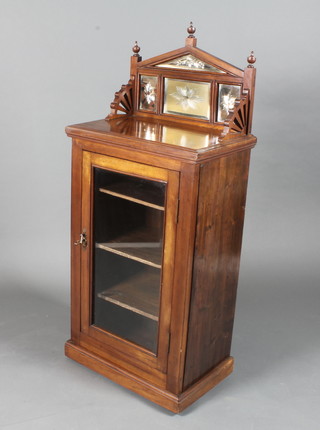 A late Victorian mahogany music cabinet, the architectural back inset mirrored plates above a glazed door enclosing 3 shelves,  raised on a plinth base 51.5"h x 22"w x 14"d