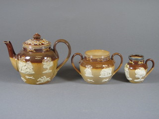 A Doulton Lambeth stoneware 3 piece tea service comprising teapot 4", sugar bowl and cream jug