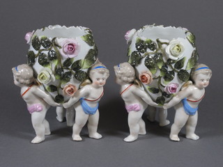 A pair of "Meissen" egg shaped vases supported by cherubs with  floral encrusted decoration, base incised 447 and with cross  sword mark 5"