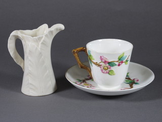 A Worcester cup and saucer with floral decoration, the base with  purple Worcester mark and a Worcester leaf shaped jug, the base  with green Worcester mark and 10 dots 4"