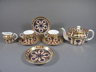 A Royal Crown Derby 8 piece tea service comprising oval teapot - chip to spout 3", 2 cups and 2 saucers, 2 tea plates 5" and a  cream jug 2", base marked 11285