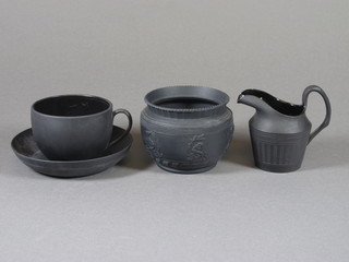 A black basalt cream jug 3", a black basalt jar 3" - lid missing  and a Wedgwood black basalt cup and saucer