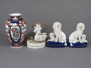 2 19th Century Staffordshire pottery figures of seated poodles  and puppies 4", a pen rest in the form of a swan with bird nest 4"  and an Imari club shaped vase 6"