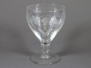 A 19th Century Masonic etched glass trumpet shaped wine glass, decorated square and compasses, sun and moon, with vinery  decoration