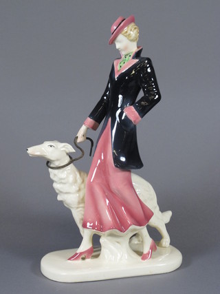 An Art Deco Continental pottery figure of a lady walking an  Afghan hound 12"