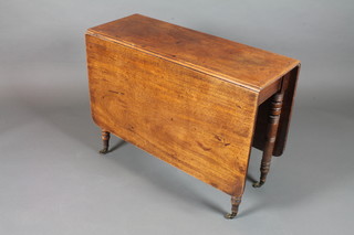 A George IV mahogany drop leaf cottage dining table raised on  ring turned tapered legs and casters 27"h x 36"w x 53"d