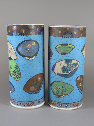 A pair of blue glazed Japanese vases with panelled floral decoration, the bases with 3 character marks, both f and r,