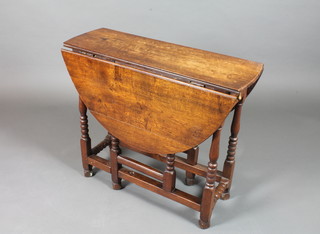 An early 18th Century oak gateleg table of small proportions, fitted an end drawer and raised on bobbin turned under frame,  block feet 29"h x 33"w