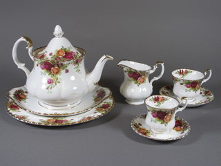 A 38 piece Royal Albert Old Country Rose pattern tea service  comprising 10" plate, 9" twin handled bread plate, teapot - chip  to spout, 2 sugar bowls 4" and 3.5", a cream jug 4", 6 tea plates  6.5", 10 saucers, 5 large cups, 4 coffee cups, 4 saucers, a square  twin handled dish 7", circular bowl 6", ashtray, butter dish 4.5"