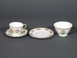 An Aynsley 21 piece floral pattern tea service comprising 9" bread plate, 6 tea plates 6", a sugar bowl, 6 cups and 6 saucers, 3  cups - cracked, decorated tulips, the base marked B3374