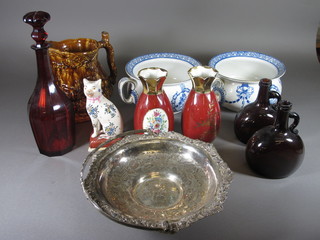 A pair of blue and white Adair chamber pots, a collection of old  brown bottles, a red glass decanter, a large treacle glazed hunting  jug etc