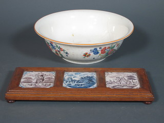 3 Delft tiles contained in an oak frame 20" x 8" and a floral  patterned pottery wash bowl - chip to base, 11"