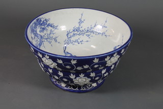 An Oriental blue and white circular jardiniere the interior decorated birds, the exterior decorated leaves with 3 character  mark to base - crack to the base, 24"