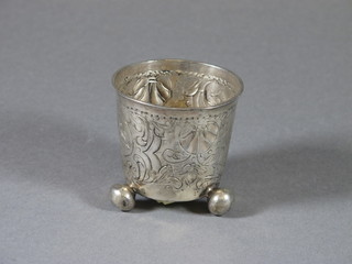 An 18th Century style circular embossed Continental silver beaker on bun feet 1 ozs