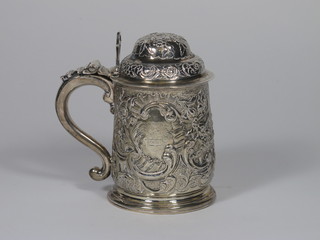 A Georgian silver lidded tankard with later embossing, London  1705, 15 ozs  ILLUSTRATED