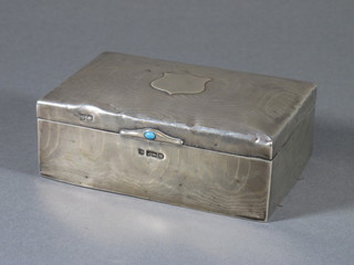 An Edwardian silver cigarette case with engine turned decoration set a cabouchon cut turquoise, Sheffield 1904, 5" long, by F.B.S  Ltd