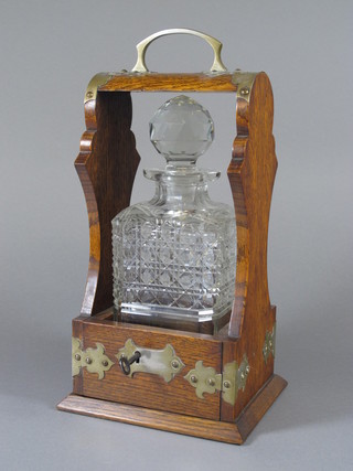 An oak and silver plated single bottle tantalus