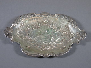 An oval embossed Continental white metal dish decorated a  cherub 2 ozs