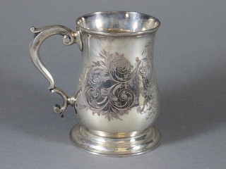 A George III baluster shaped silver tankard with scroll handle  and engraved decoration, London 1757 by Thomas Whipman &  Charles Wright, 9 ozs  ILLUSTRATED